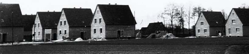 Siedlungshäuser im Rohbau, dazwischen der alte Brinkhof